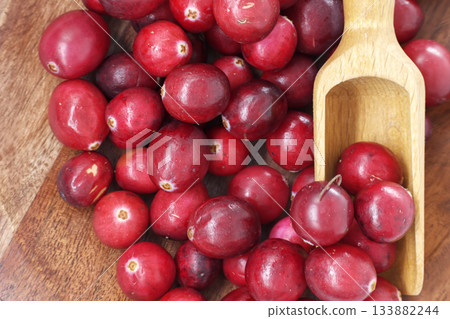 Fresh Red Cranberries In Wooden Scoop On Rustic Wood Board For Holiday Cooking Fresh Red Cranberries In Wooden Scoop On Rustic Wood Board For Holiday Cooking 133882244