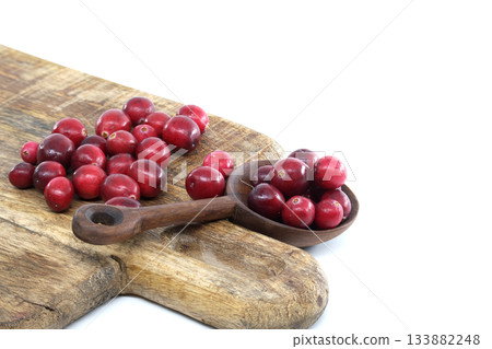 Red Cranberries on Rustic Wooden Board With Scoop. Fresh, Seasonal Holiday Garnish Red Cranberries on Rustic Wooden Board With Scoop. Fresh, Seasonal Holiday Garnish 133882248