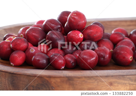 Fresh cranberries in a wooden bowl, ready for cooking or eating 133882250