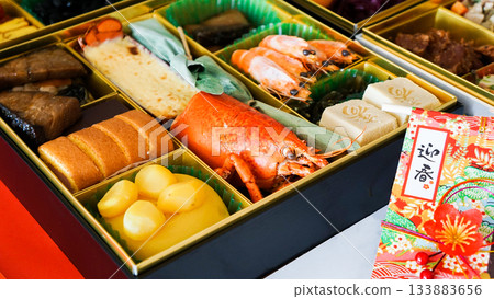 A tiered box of osechi dishes and a luxurious New Year's assortment 133883656