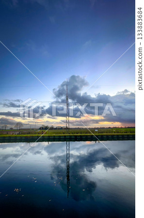 A Majestic Reflection of a Tower Can Be Seen in a Beautiful and Serene Landscape A Majestic Reflection of a Tower Can Be Seen in a Beautiful and Serene Landscape 133883684