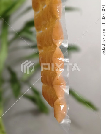 Hand Holding Orange Portion Pouches for Freezing Hand Holding Orange Portion Pouches for Freezing 133883871