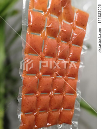 Hand Holding Orange Portion Pouches for Freezing Hand Holding Orange Portion Pouches for Freezing 133883906