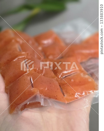 Hand Holding Orange Portion Pouches for Freezing Hand Holding Orange Portion Pouches for Freezing 133883910