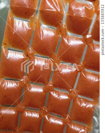 Small Square Orange Food Pouches in Grid Packaging 133883912