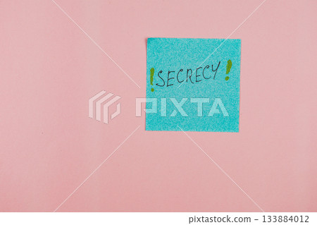 Sticky note with the word secrecy written on it against a pink background 133884012