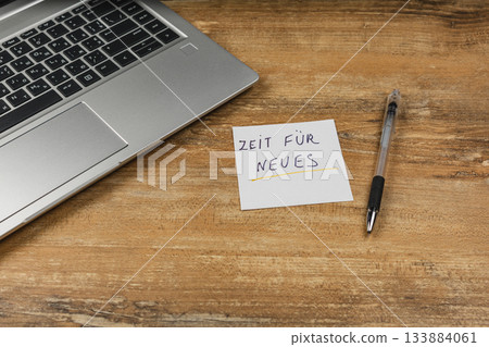 Notes on a desk next to a laptop indicating a time for new beginnings 133884061