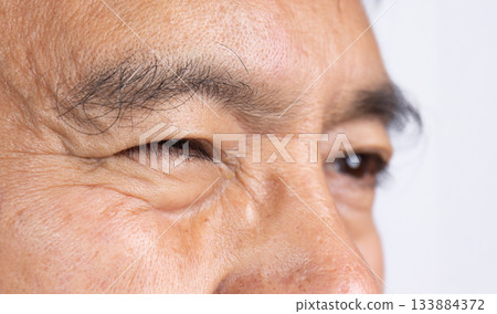 Senior man eye strain after for long stretches at digital screens. Senior man eye strain after for long stretches at digital screens. 133884372