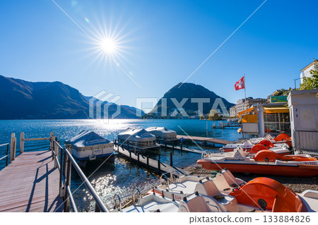 Lugano central ferry terminal and lakeside promenade. Lugano, Ticino, Switzerland Lugano central ferry terminal and lakeside promenade. Lugano, Ticino, Switzerland 133884826