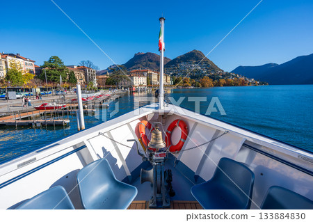 Interior of a sightseeing boat and view of the lake. Lugano, Ticino, Switzerland Interior of a sightseeing boat and view of the lake. Lugano, Ticino, Switzerland 133884830