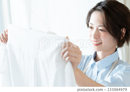 年輕的女士掛洗衣 133884979