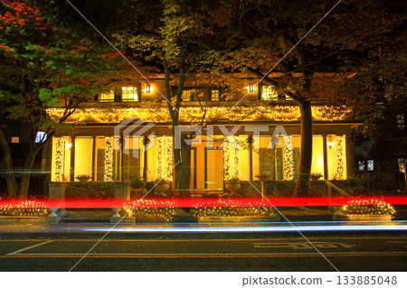 The trail of a car passing in front of the illuminated Yamate 234th Building 133885048