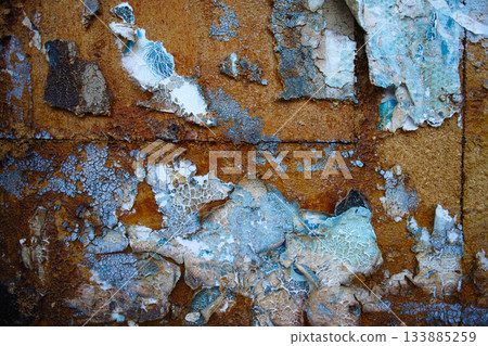 Peeling paint and paper on rusty wall surface Peeling paint and paper on rusty wall surface 133885259