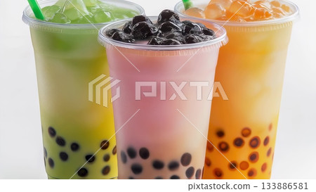 Boba tea selection displaying vibrant plastic cups with tapioca pearls, presenting colorful refreshment styles against clean white surface 133886581