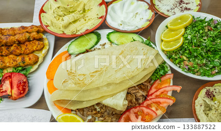 Arabic Cuisine: Middle Eastern traditional lunch. Assorted of Arabic oriental dishes. top view Arabic Cuisine: Middle Eastern traditional lunch. Assorted of Arabic oriental dishes. top view 133887522