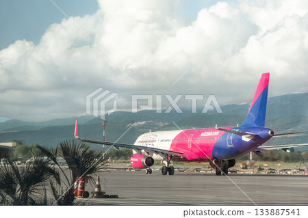 Wizzair passenger plane at Tirana International Airport through the window of departing terminal Wizzair passenger plane at Tirana International Airport through the window of departing terminal 133887541