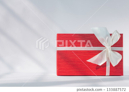Red gift box with white bow on white background. Holiday greeting card 133887572
