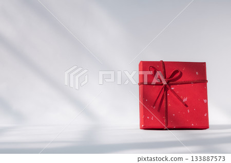Gift box with red bow on white background. Holiday greeting card, top view 133887573