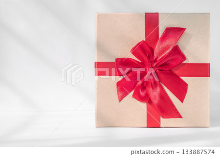 Gift box with red bow on white background. Holiday greeting card 133887574