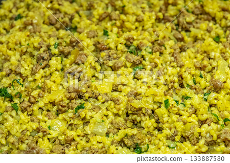Broken wheat or Dalia Upma, served in a bowl with minced meat. selective focus 133887580