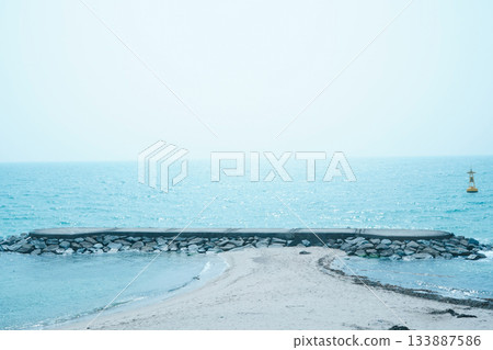 Korean East Sea Beach with Calm Waves and the Horizon Meeting the Blue Sky Korean East Sea Beach with Calm Waves and the Horizon Meeting the Blue Sky 133887586