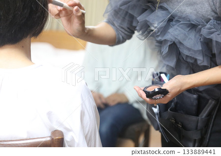 Woman doing make-up Woman doing make-up 133889441