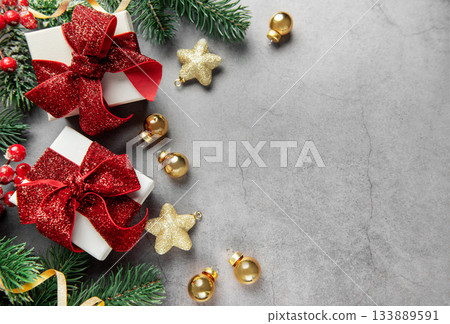 Christmas presents with festive decorations on gray background Christmas presents with festive decorations on gray background 133889591