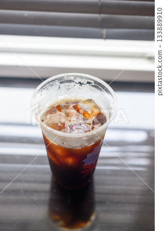 Iced black coffee in a plastic cup Iced black coffee in a plastic cup 133889910