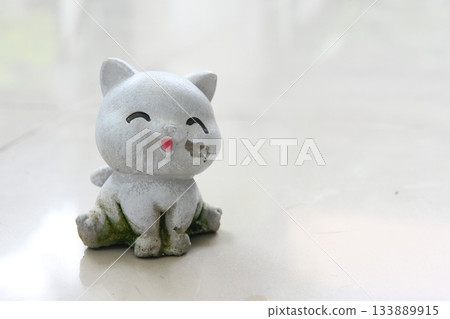 A damaged and dirty cat plaster sculpture. A damaged and dirty cat plaster sculpture. 133889915