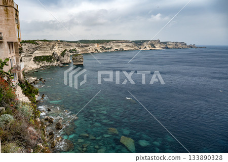 Aerial view marina cape Bonifacio south Corsica France citadel on rocky promontory on wild white limestone cliffs 133890328