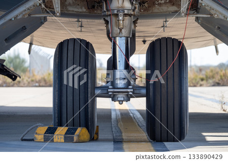 Aircraft nose landing gear on runway centerline Aircraft nose landing gear on runway centerline 133890429