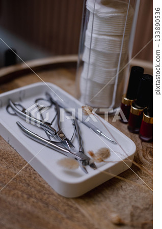 Detailed view of professional manicure procedure with nail care tools and hands in focus. 133890536
