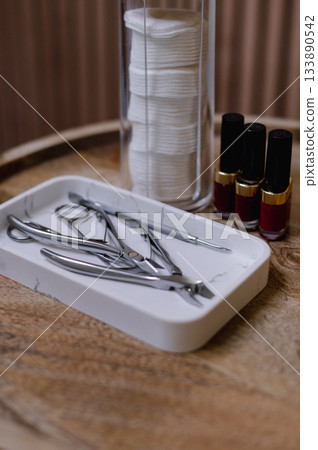 Detailed view of professional manicure procedure with nail care tools and hands in focus. Detailed view of professional manicure procedure with nail care tools and hands in focus. 133890542