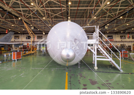 Front view of fighter jet radome and nose gear in hangar Front view of fighter jet radome and nose gear in hangar 133890620