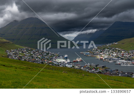 Breathtaking panoramic view of Klaksvik city, nestled among fjords and mountains in the Faroe Islands, Denmark, North Atlantic. Breathtaking panoramic view of Klaksvik city, nestled among fjords and mountains in the Faroe Islands, Denmark, North Atlantic. 133890657