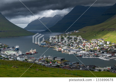 Breathtaking panoramic view of Klaksvik city, nestled among fjords and mountains in the Faroe Islands, Denmark, North Atlantic. Breathtaking panoramic view of Klaksvik city, nestled among fjords and mountains in the Faroe Islands, Denmark, North Atlantic. 133890678