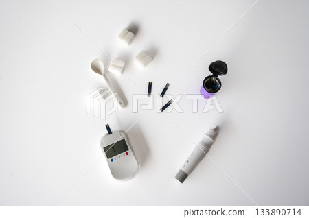 Close-up of a man's hands using a lancet on his finger to test blood glucose level. Concept of diabetes care, glycemia monitoring, and health management. 133890714