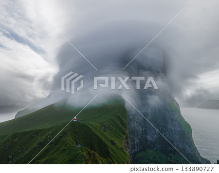 Kallur lighthouse on green hills of Kalsoy island, Faroe islands, Denmark. Landscape photography. High quality photo 133890727