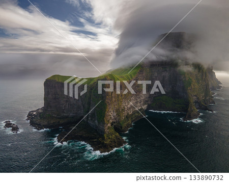 Aerial view of Kallur lighthouse on green hills of Kalsoy island, Faroe islands, Denmark. Landscape photography. High quality photo 133890732