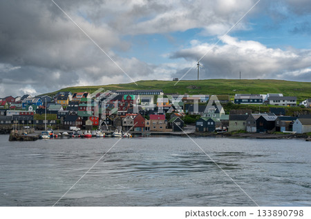 Scenic view of Nolsoy, Faroe Islands, with colorful fishermens houses by the sea, reflecting traditional Nordic charm and coastal lifestyle. Scenic view of Nolsoy, Faroe Islands, with colorful fishermens houses by the sea, reflecting traditional Nordic charm and coastal lifestyle. 133890798