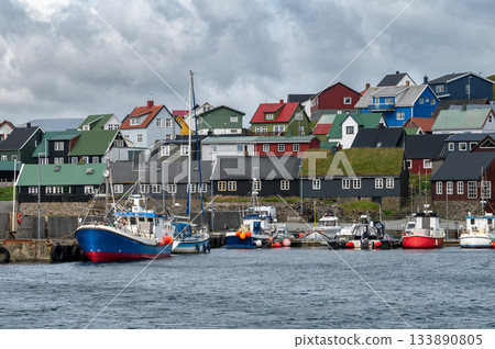 Scenic view of Nolsoy, Faroe Islands, with colorful fishermens houses by the sea, reflecting traditional Nordic charm and coastal lifestyle. Scenic view of Nolsoy, Faroe Islands, with colorful fishermens houses by the sea, reflecting traditional Nordic charm and coastal lifestyle. 133890805