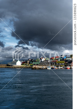 Scenic view of Nolsoy, Faroe Islands, with colorful fishermens houses by the sea, reflecting traditional Nordic charm and coastal lifestyle. Scenic view of Nolsoy, Faroe Islands, with colorful fishermens houses by the sea, reflecting traditional Nordic charm and coastal lifestyle. 133890823