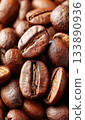 Roasted coffee beans creating background texture pattern 133890936