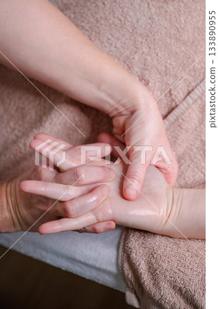 Relaxing massage therapy for young women in calming setting, dark light. High quality photo 133890955