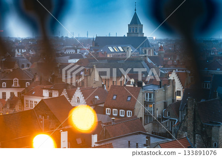 Festive Bruges square illuminated with Christmas lights and decorations, showcasing holiday market stalls and charming historic architecture. Festive Bruges square illuminated with Christmas lights and decorations, showcasing holiday market stalls and charming historic architecture. 133891076