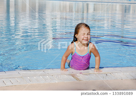 Little adorable child girl enjoying summer in the beach. Swimming in the pool Little adorable child girl enjoying summer in the beach. Swimming in the pool 133891089