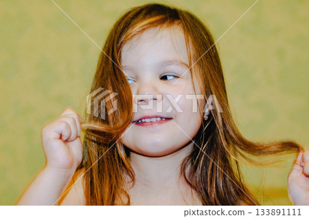 Beautiful happy toddler child girl smiling, natural emotions. Long hair, adorable girl 133891111