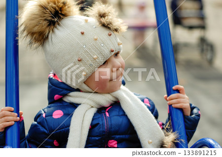 Cute Adorable Toddler Having Fun Times and Adventures at the Local Neighborhood Playground. Healthy happy baby child playing in the park. Stylish clothes for kids Cute Adorable Toddler Having Fun Times and Adventures at the Local Neighborhood Playground. Healthy happy baby child playing in the park. Stylish clothes for kids 133891215