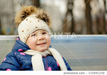 Cute Adorable Toddler Having Fun Times and Adventures at the Local Neighborhood Playground. Healthy happy baby child playing in the park. Stylish clothes for kids 133891230