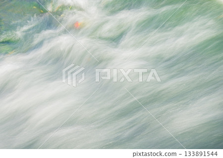 A torrent of water splashing along 133891544